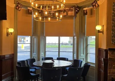 Café blinds installation creating warm indoor ambience
