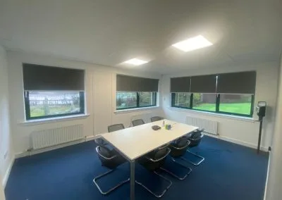 Commercial blind installation across open-plan office
